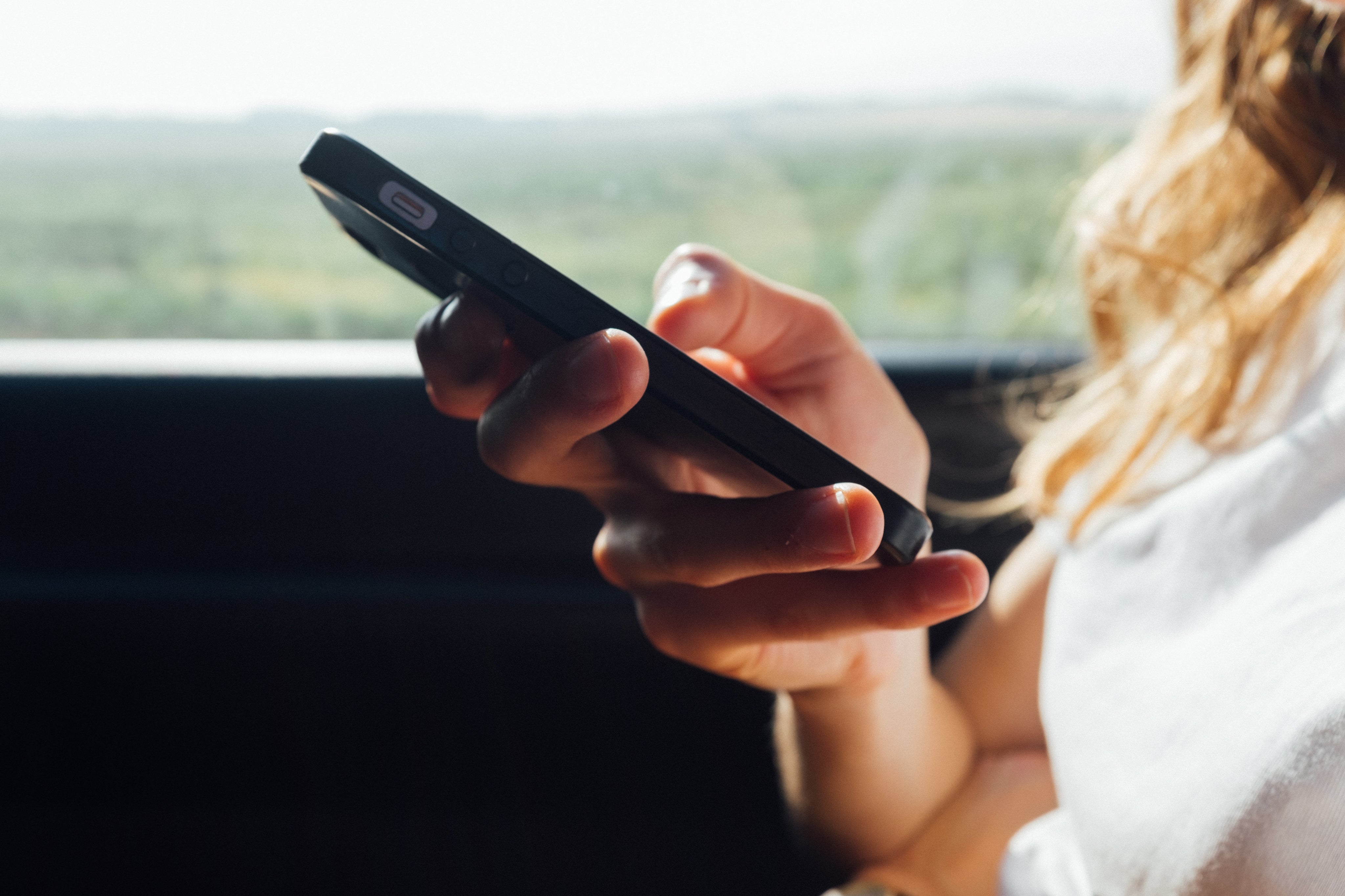 A woman using mobile phone to search for online vapes