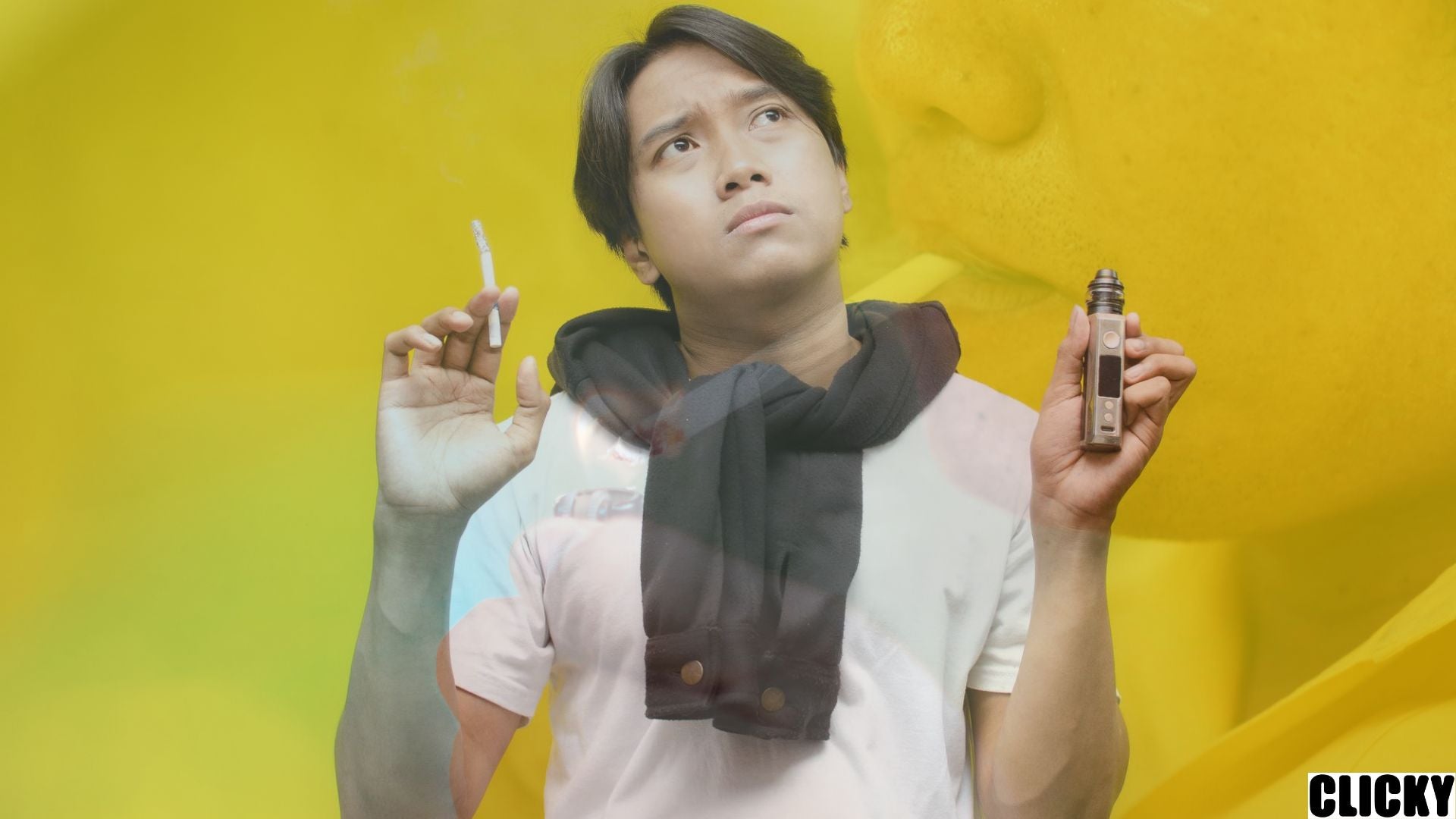 A guy holding cigarettes and vape device thinking about the Akta 852 Malaysia